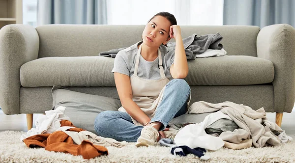 Young Mixed Race Domestic Cleaner Looking Distracted Overwhelmed While Folding — Stock Photo, Image