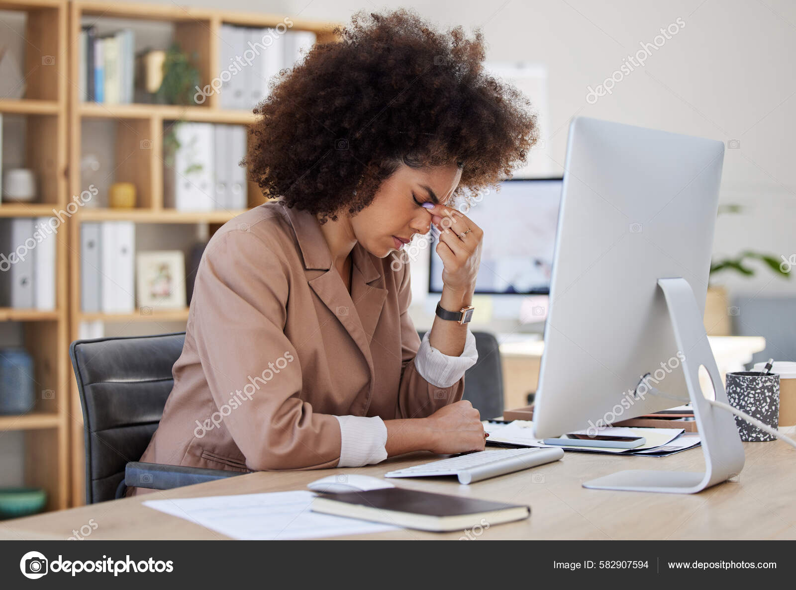 mixed race young woman typing on computer keyboard at table with