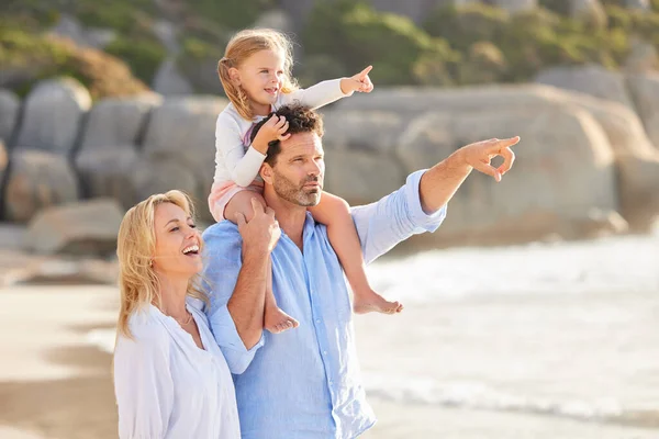 かわいい娘と妻とビーチで時間を過ごす白人男性の閉鎖 ビーチで妻と歩いている間に彼の娘を肩に担いでいる男性 — ストック写真