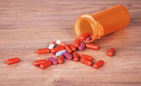 Open Orange Bottle Brightly Coloured Pills Spilled Wooden Table Vitamin — Fotografia de Stock