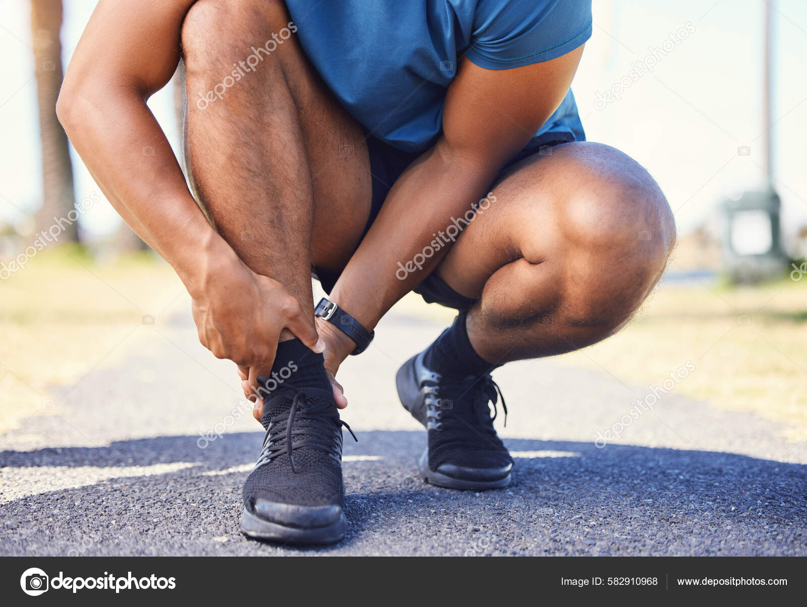 Closeup Active Mixed Race Man Holding His Ankle Pain While — Stock - Main Image