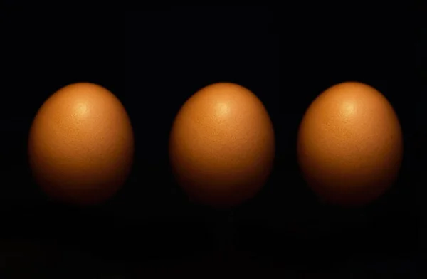 Tres Huevos Frescos Enteros Fila Alineados Contra Fondo Oscuro Estudio —  Fotos de Stock