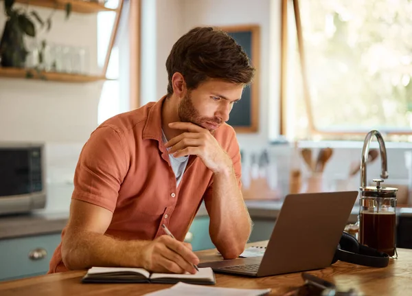Young Caucasian Businessman Writing Notebook Working Laptop Home Alone Focused — Fotografia de Stock