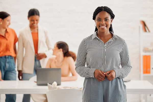 Young happy african american businesswoman standing in an office at work. Confident black female businessperson in a meeting at work.