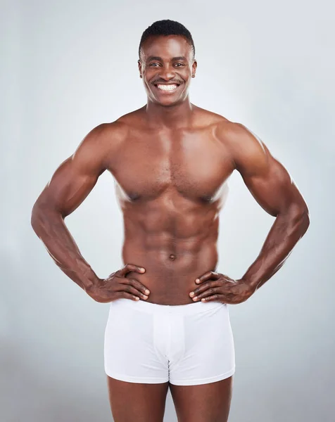 一个面带微笑的非洲裔美国人健身模特的画像 穿着内裤 看起来很有肌肉 快乐的黑人男性运动员 穿着拳击服 在灰色的包厢里被隔离 — 图库照片