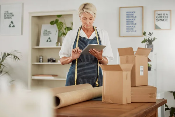 Packing, shipping and logistics in a modern workplace. Boxes being prepared for sending out.