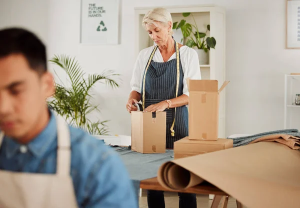 Packing, shipping and logistics in a modern workplace. Boxes being prepared for sending out.