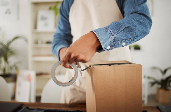 Packing, shipping and logistics in a modern workplace. Boxes being prepared for sending out.