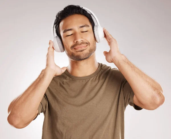 Handsome Young Mixed Race Man Listening Music While Standing Studio — Foto de Stock