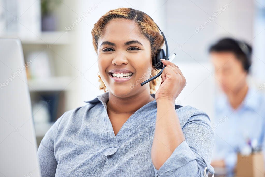 Closeup of smiling mixed race female call center agent talking on headset. Business woman or translator answering calls in an office. Hispanic female customer service agent on the line.