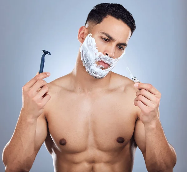 Shot Young Man Unable Decide Razors Studio Background — Stock Photo, Image