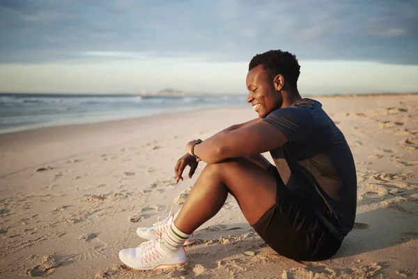 African American Muscular Man Looking Happy Carefree While Sitting Beach – stockfoto