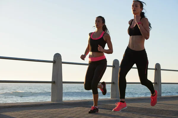 Shot Two Attractive Young Female Athletes Exercising Outdoors — Stok fotoğraf