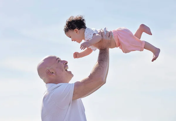 Cheerful Mature Dad Grandfather Lifting Little Girl Clear Blue Sky —  Fotos de Stock