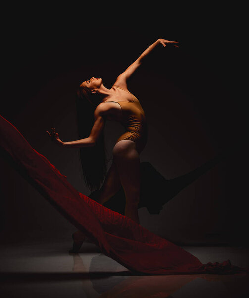 Shot of a performer dancing against a dark background.