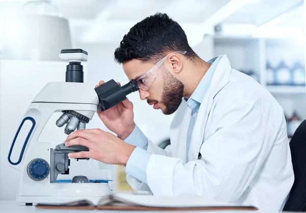 One Serious Young Male Medical Scientist Sitting Desk Using Microscope — Stockfoto