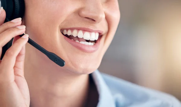Cropped Close Up of a unknown smiling mixed race call centre agent talking to customers with a wireless technology headset. Hispanic businesswoman answering calls, helping clients from an office