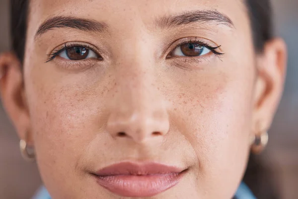 Closeup portrait of face of a serious businesswoman. Focused hispanic business professional standing in her office. Powerful, leading single female only in her workplace. Face of a beautiful woman.