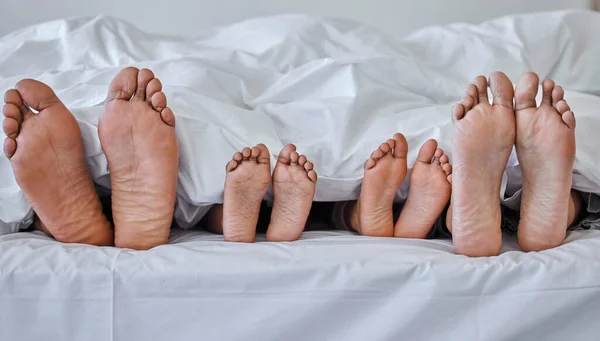 Shot Family Laying Barefoot Bed Home — Stock Photo, Image