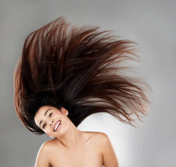 Studio Portrait Beautiful Young Woman Flowing Hair Grey Background — Zdjęcie stockowe