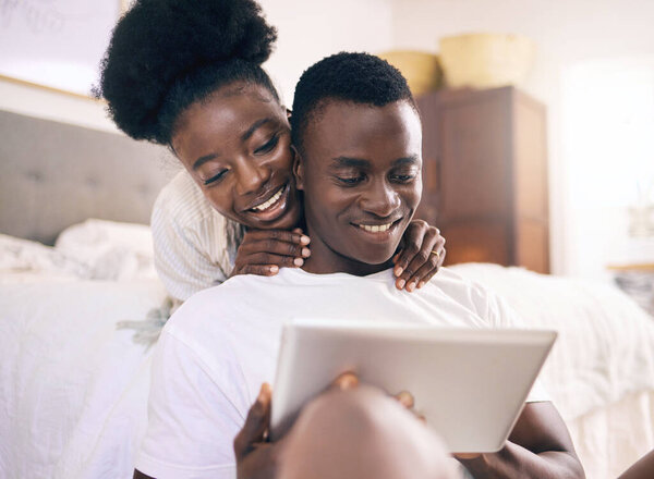 Shot of a young couple using a digital tablet together at home.