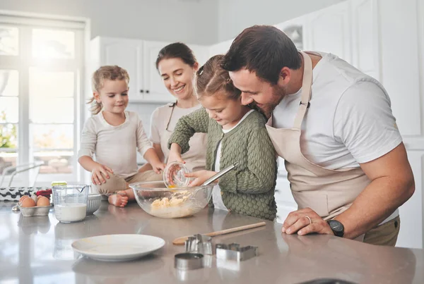 Shot of a family baking together in the kitchen.