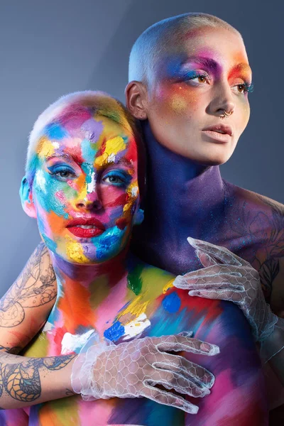 Studio Shot Two Young Women Posing Multi Coloured Paint Her — Zdjęcie stockowe
