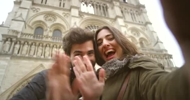 Happy Young Couple Waving Video Call Front Notre Dame — Vídeos de Stock