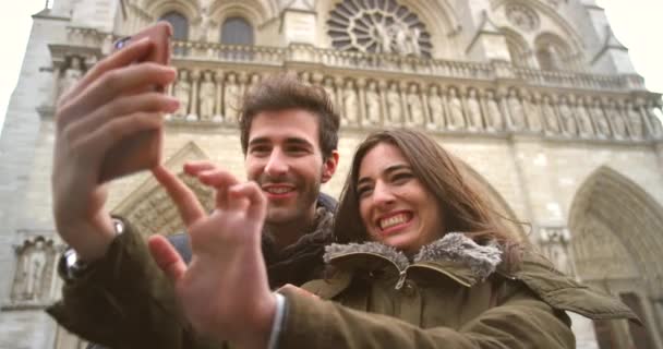 Cheerful Young Couple Taking Selfies Cellphone Front Notre Dame — Stock video