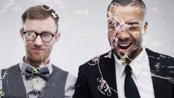 Video Footage Two Friends Being Sprayed Confetti Studio Background — Stockvideo