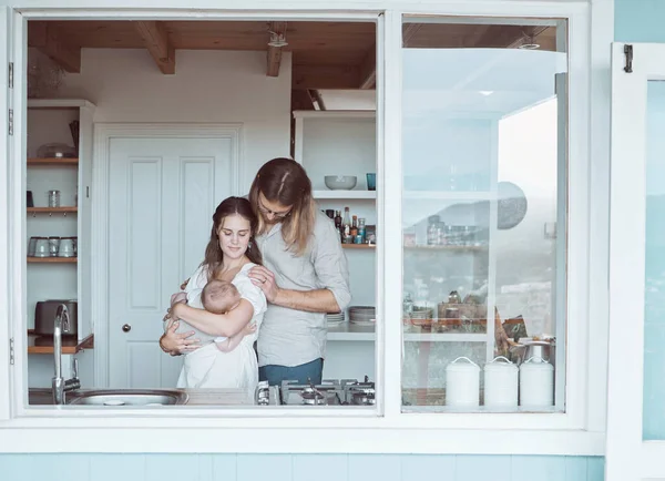 Foto Una Familia Joven Sosteniendo Recién Nacido Cariñosamente Cocina Casa — Foto de Stock