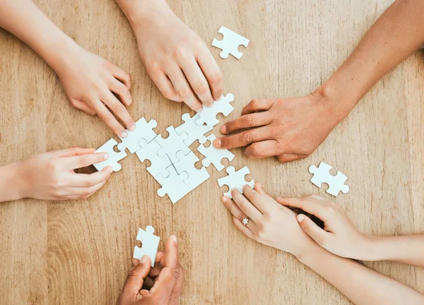 Shot of a family building a puzzle together at home.