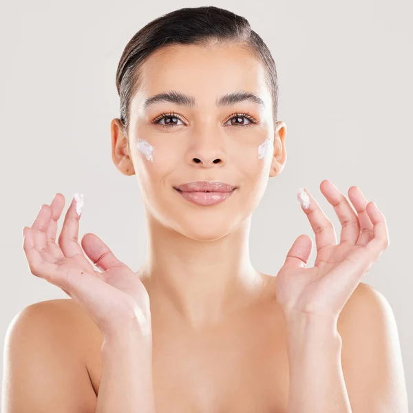 Shot Young Woman Applying Cream Her Face Grey Background — Stockfoto