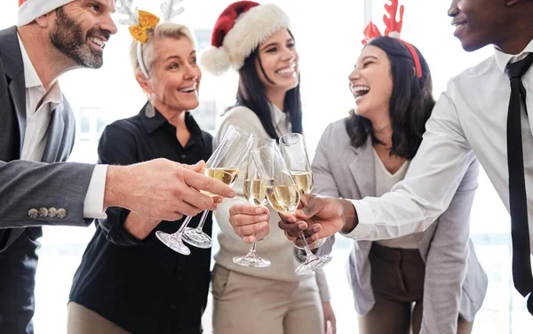 Shot of a group of businesspeople toasting at a Christmas party at work.