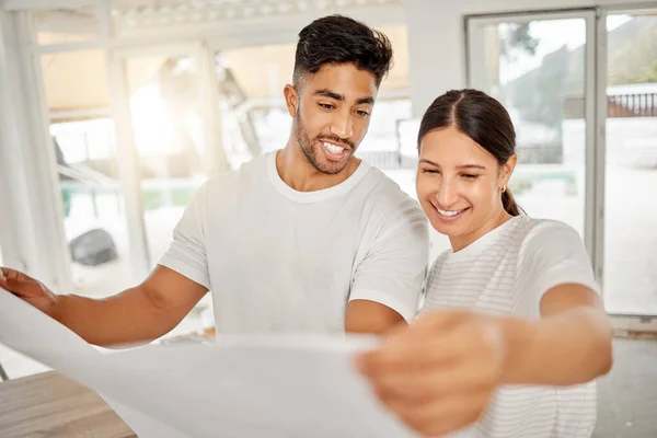 Shot Young Couple Standing Together Looking Building Plans Home — Stockfoto