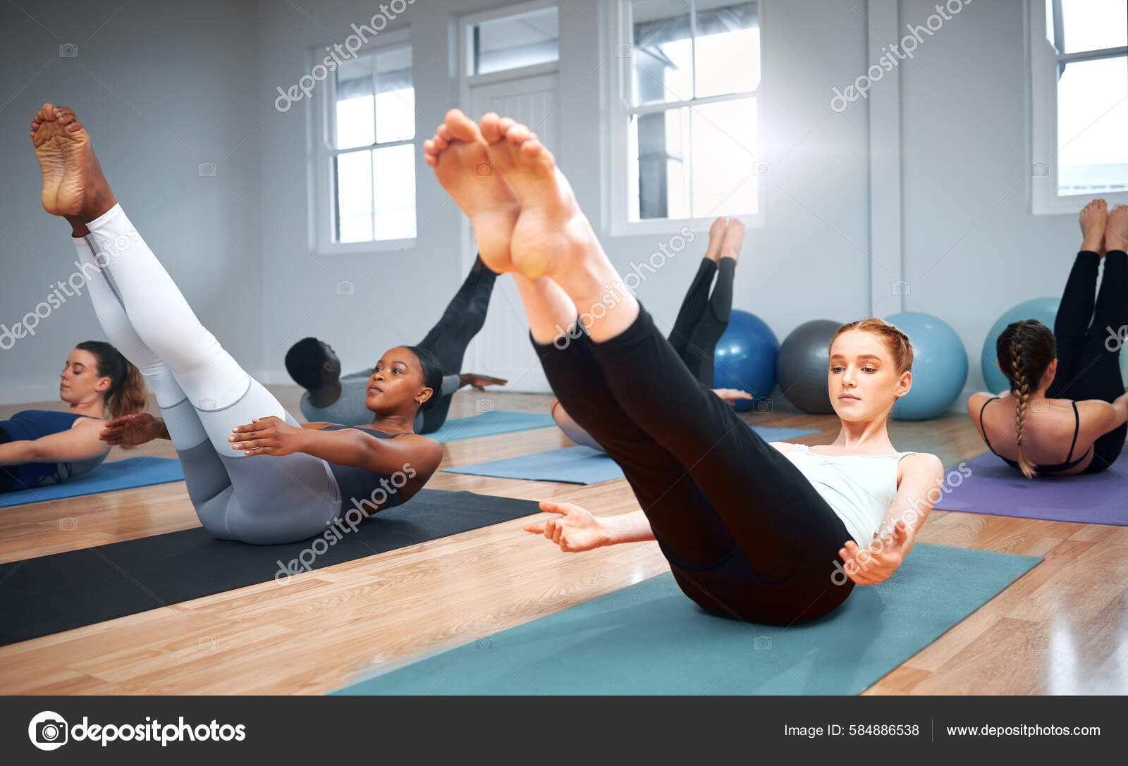 Shot Group Students Performing Crunches Pilates Class Stock Photo PeopleImages 584886538