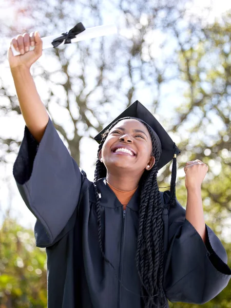 Shot of a young woman cheering on graduation day.