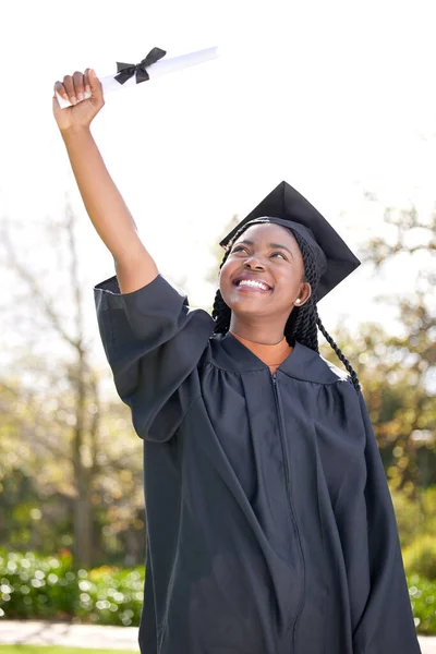 Shot of a young woman cheering on graduation day.