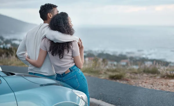 Shot of a young couple on a road trip together.