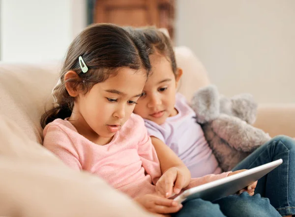 Shot Two Little Girls Sitting Together While Using Digital Tablet —  Fotos de Stock