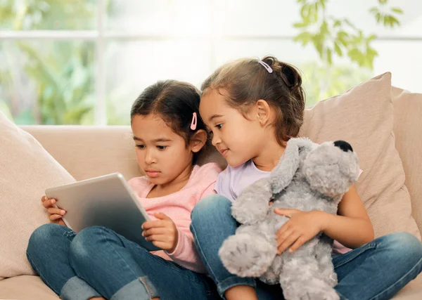 Shot Two Little Girls Sitting Together While Using Digital Tablet —  Fotos de Stock