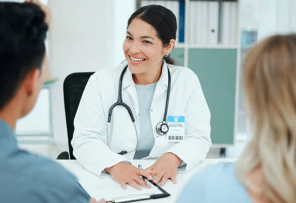 Shot of a couple consulting with a doctor at a clinic.