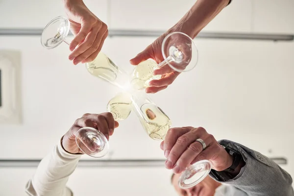 Below shot of a group of business colleagues having a celebratory drink in an office.