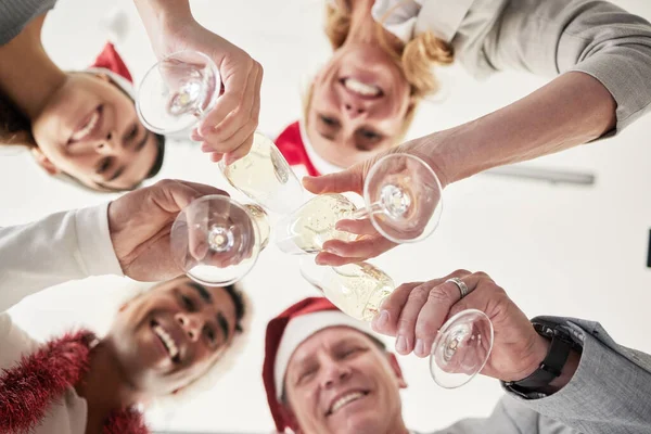 Below shot of a group of business colleagues having a celebratory drink in an office.