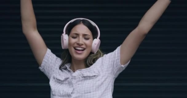 Mujer Escuchando Música Auriculares Bailando Con Los Brazos Levantados Mientras — Vídeo de stock