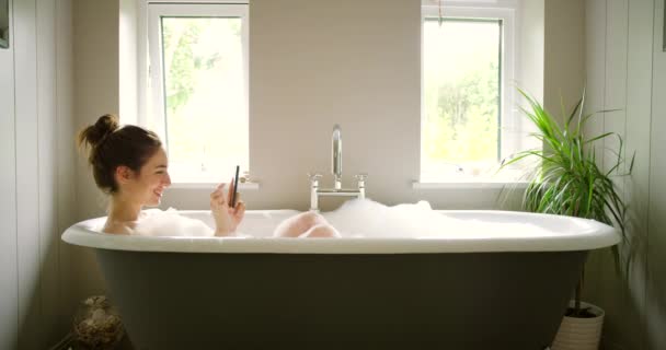 Happy Woman Taking Photos Using Her Smartphone Afternoon Bubble Bath — Vídeos de Stock