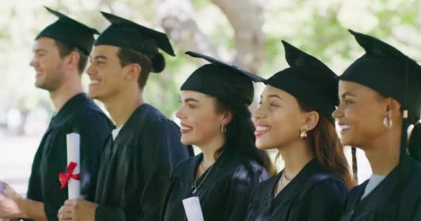 Group University College Graduates Mortarboards Gowns Standing Line Graduation Ceremony — Stockvideo