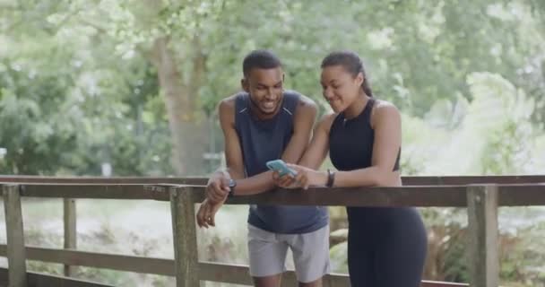 Two Athletes Using Phone Track Health Fitness Progress While Enjoying — Videoclip de stoc