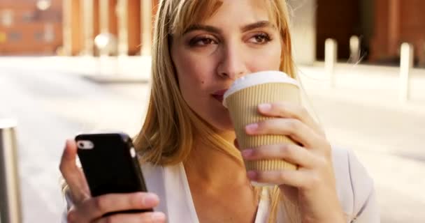 Video Footage Young Businesswoman Drinking Coffee While Using Her Cellphone — Stock videók