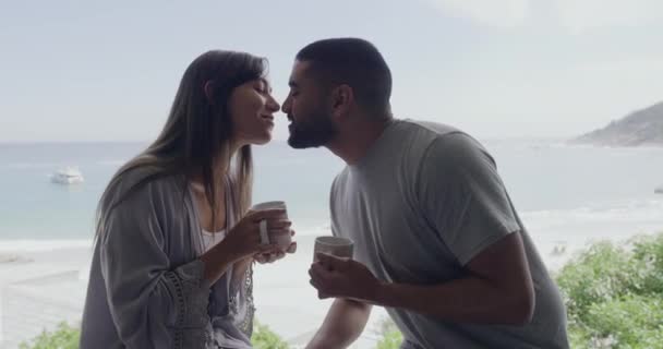 Young Interracial Couple Kissing Drinking Coffee While Sitting Beach Background — Stockvideo